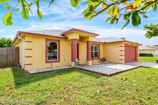 view of front of house featuring a front yard and a garage