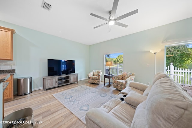 living room with ceiling fan and light wood-type flooring