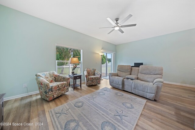 living room featuring ceiling fan and light hardwood / wood-style flooring