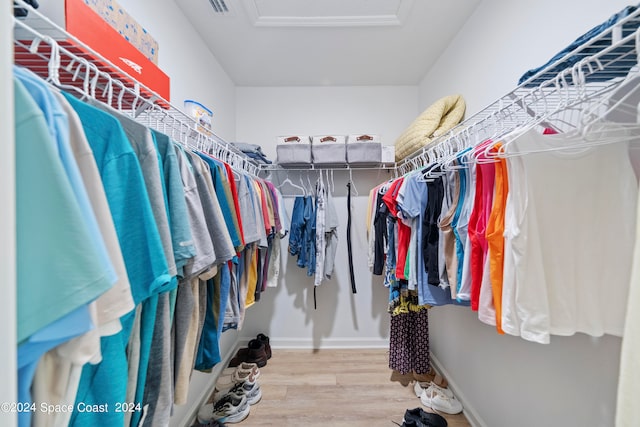 walk in closet with hardwood / wood-style floors