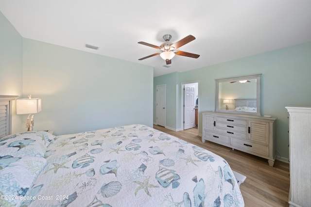 bedroom with ceiling fan and light hardwood / wood-style flooring