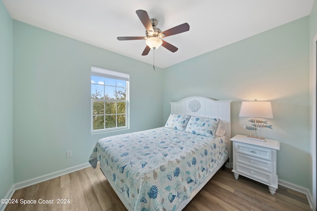 bedroom with wood-type flooring and ceiling fan