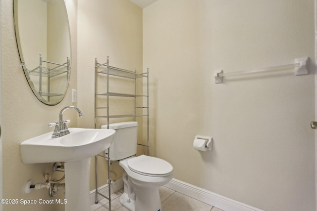 929 Hialeah St, Rockledge, FL 32955 - bathroom with tile patterned flooring, baseboards, and toilet