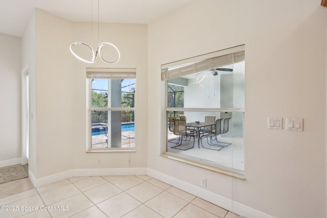 929 Hialeah St, Rockledge, FL 32955 - unfurnished dining area with tile patterned floors and baseboards