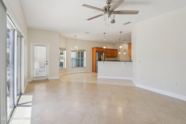 929 Hialeah St, Rockledge, FL 32955 - unfurnished living room featuring visible vents, ceiling fan, light tile patterned flooring, and baseboards
