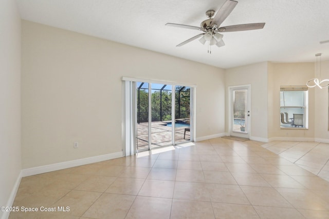 929 Hialeah St, Rockledge, FL 32955 - spare room with light tile patterned floors, baseboards, and a ceiling fan