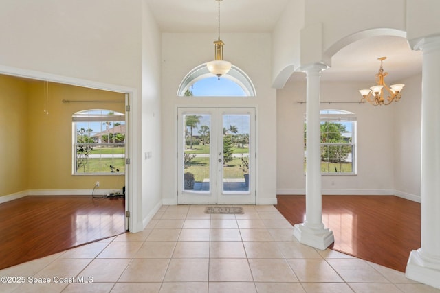 929 Hialeah St, Rockledge, FL 32955 - entrance foyer with french doors, decorative columns, arched walkways, and plenty of natural light
