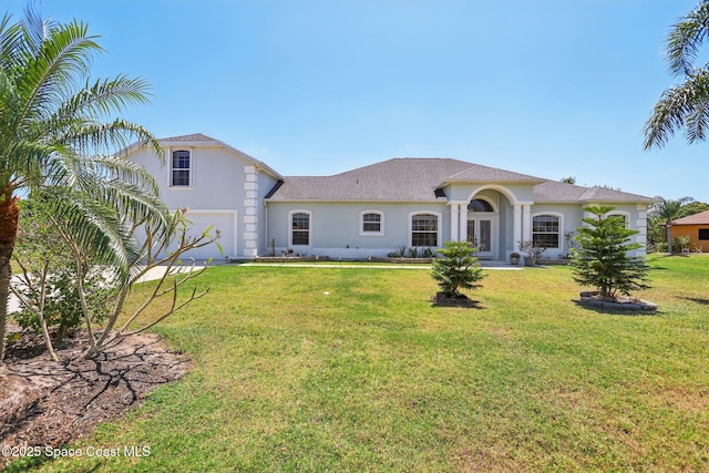 929 Hialeah St, Rockledge, FL 32955 - view of front of property featuring a front lawn, a garage, and stucco siding