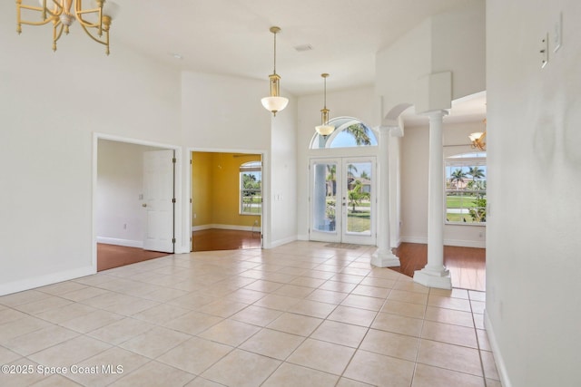 929 Hialeah St, Rockledge, FL 32955 - interior space with ornate columns, light tile patterned floors, a notable chandelier, and a wealth of natural light