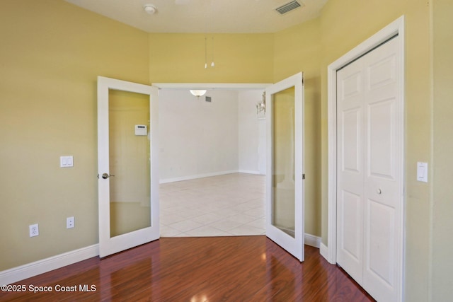 929 Hialeah St, Rockledge, FL 32955 - unfurnished room featuring french doors, baseboards, wood finished floors, and visible vents