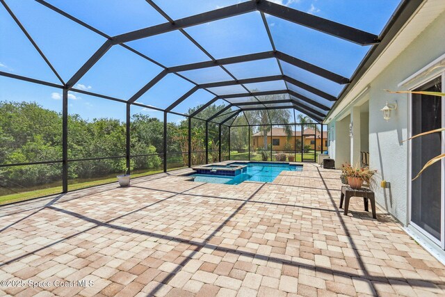 929 Hialeah St, Rockledge, FL 32955 - view of swimming pool featuring a lanai, a patio area, and a pool with connected hot tub