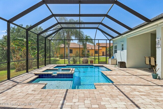 929 Hialeah St, Rockledge, FL 32955 - view of pool with a patio area, a pool with connected hot tub, and glass enclosure