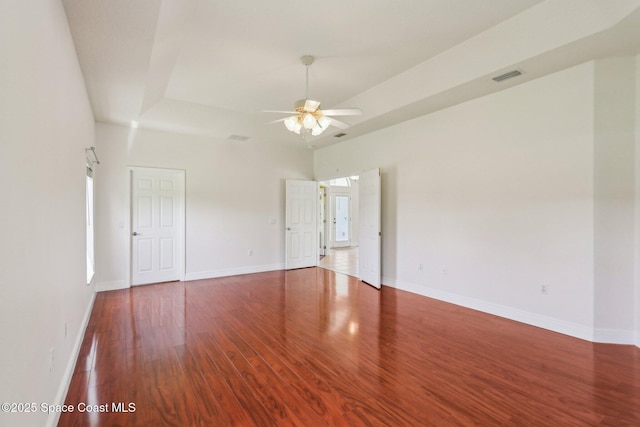 929 Hialeah St, Rockledge, FL 32955 - spare room with baseboards, visible vents, a tray ceiling, ceiling fan, and wood finished floors