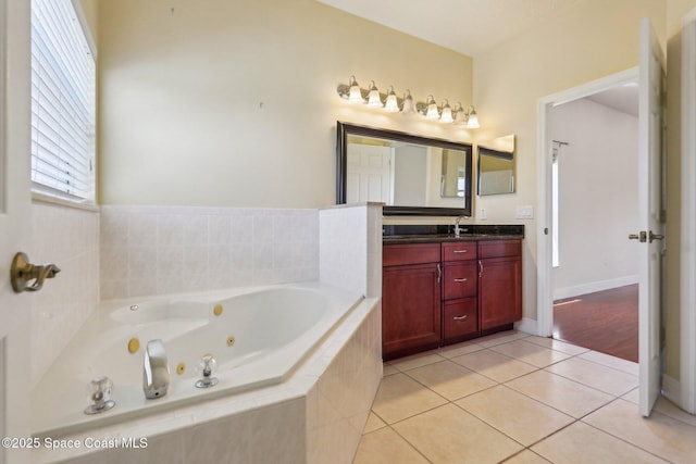 929 Hialeah St, Rockledge, FL 32955 - bathroom featuring a whirlpool tub, tile patterned flooring, and vanity