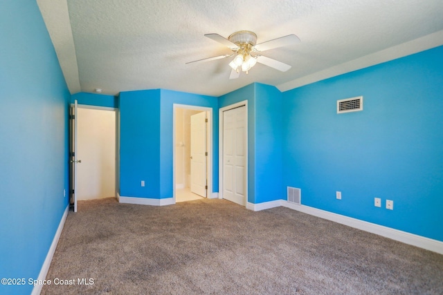 929 Hialeah St, Rockledge, FL 32955 - unfurnished bedroom featuring a textured ceiling, carpet flooring, and visible vents
