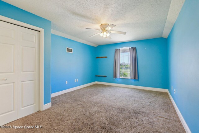929 Hialeah St, Rockledge, FL 32955 - unfurnished bedroom with visible vents, a textured ceiling, carpet flooring, and a closet