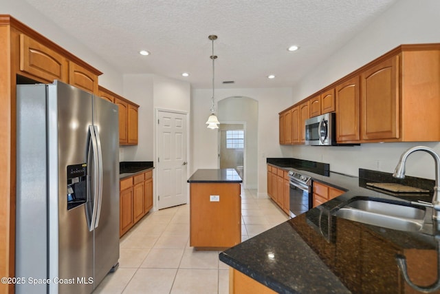 929 Hialeah St, Rockledge, FL 32955 - kitchen with light tile patterned floors, recessed lighting, a center island, appliances with stainless steel finishes, and a sink
