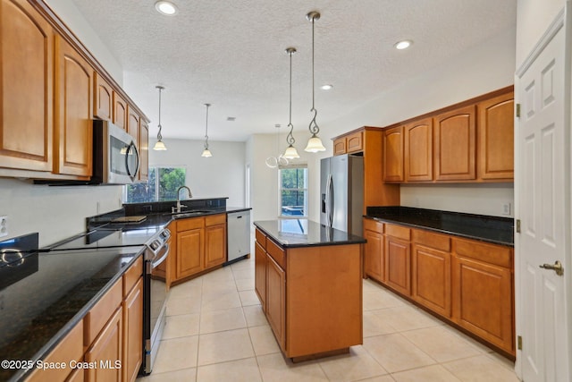 929 Hialeah St, Rockledge, FL 32955 - kitchen with dark stone countertops, a sink, appliances with stainless steel finishes, brown cabinets, and a kitchen island