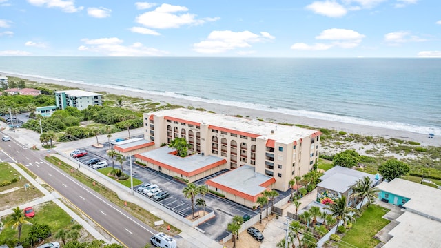 drone / aerial view featuring a view of the beach and a water view