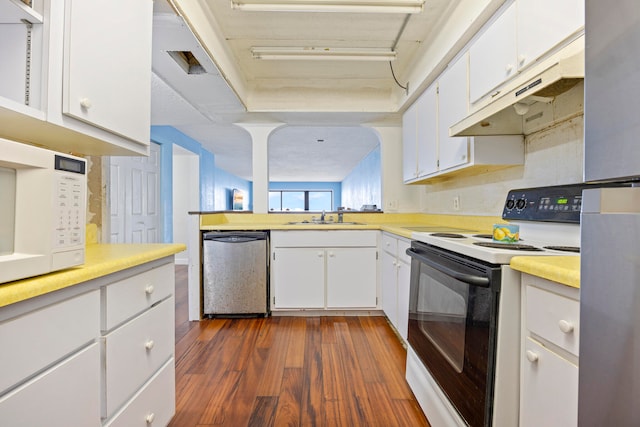 kitchen with white appliances, sink, dark wood-type flooring, and white cabinets