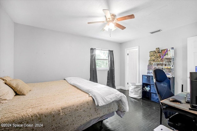 bedroom with ceiling fan and dark wood-type flooring