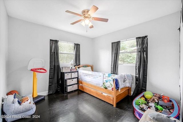 bedroom featuring dark wood-type flooring, multiple windows, and ceiling fan