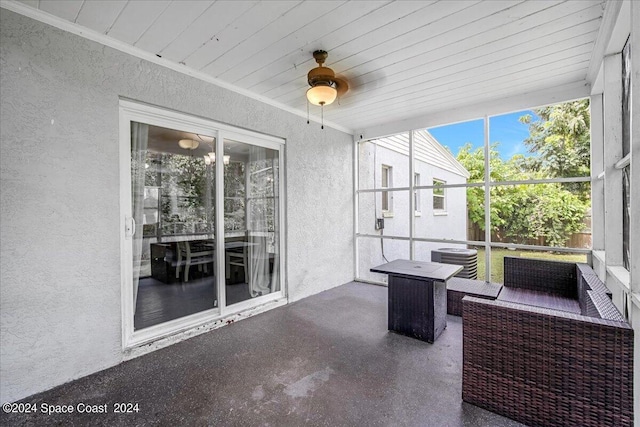 sunroom featuring wooden ceiling and ceiling fan