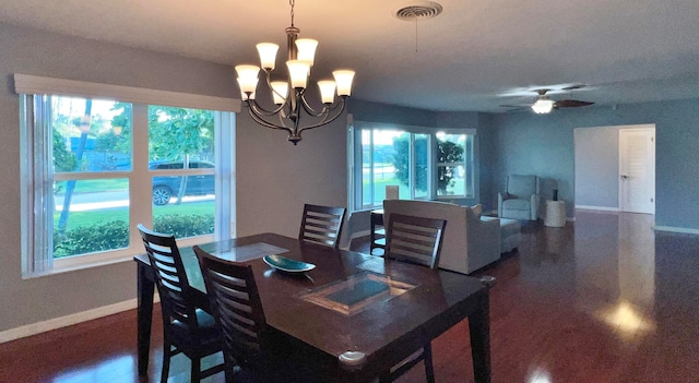 dining room with ceiling fan with notable chandelier and plenty of natural light