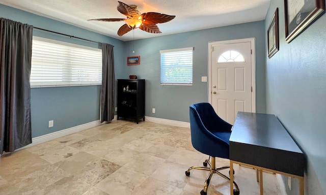 office space with ceiling fan and a textured ceiling