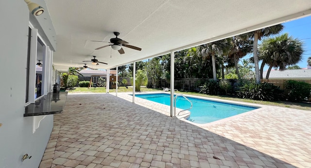 view of swimming pool with a patio and ceiling fan