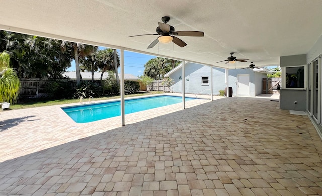 view of pool featuring ceiling fan and a patio area