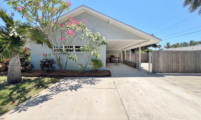 view of property exterior with a carport