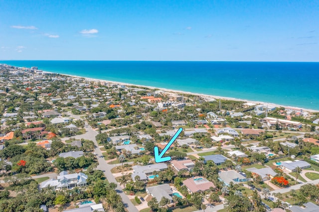 bird's eye view featuring a water view and a beach view