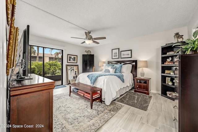 bedroom featuring a textured ceiling, ceiling fan, and access to exterior