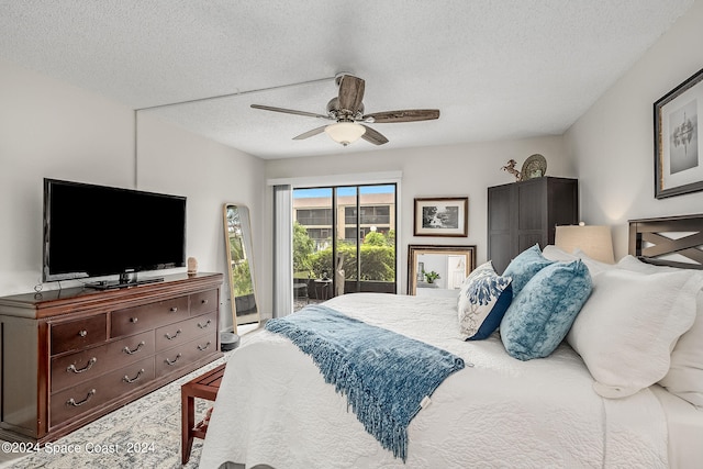 bedroom with ceiling fan, access to outside, and a textured ceiling