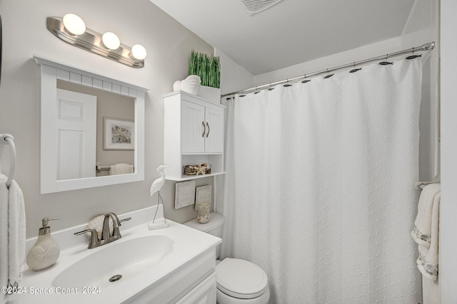 bathroom featuring vanity and toilet