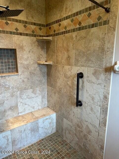 bathroom with tiled shower