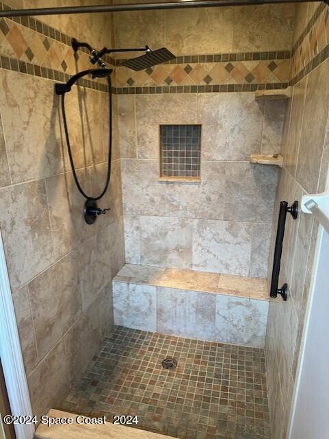 bathroom with a tile shower