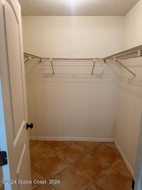 walk in closet featuring tile patterned flooring