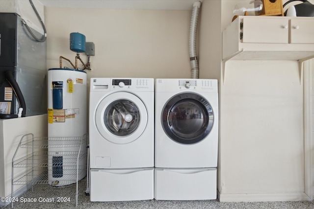 laundry room featuring washing machine and dryer and electric water heater