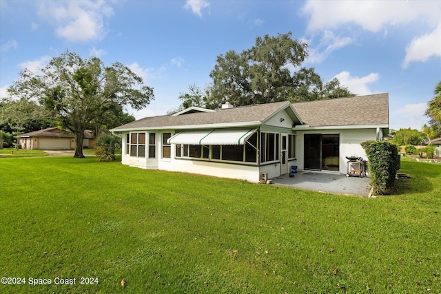 back of house with a sunroom and a lawn