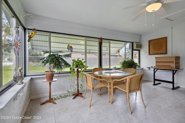 sunroom featuring an AC wall unit and ceiling fan