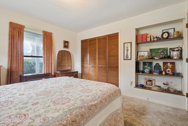 carpeted bedroom with a textured ceiling and a closet