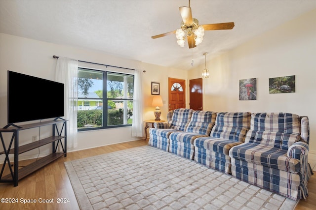 living room with ceiling fan and light hardwood / wood-style flooring