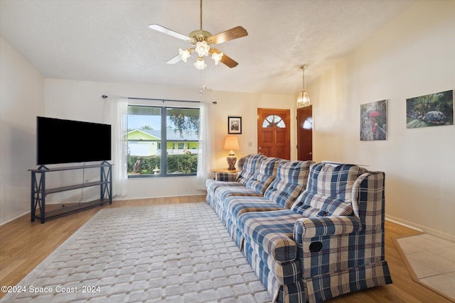 living room featuring light wood-type flooring, ceiling fan, and lofted ceiling