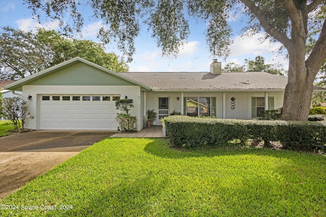 ranch-style home with a garage and a front lawn