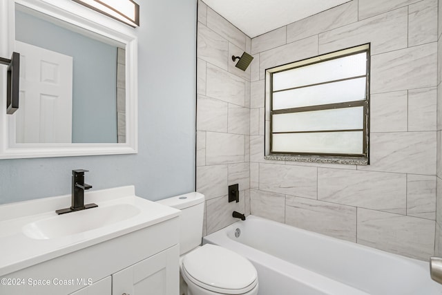 full bathroom with vanity, toilet, and tiled shower / bath combo