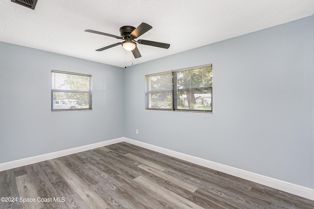 spare room featuring hardwood / wood-style flooring and ceiling fan