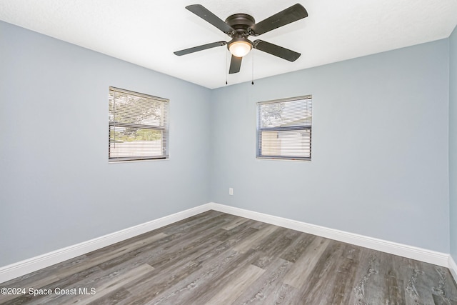 spare room with wood-type flooring and ceiling fan