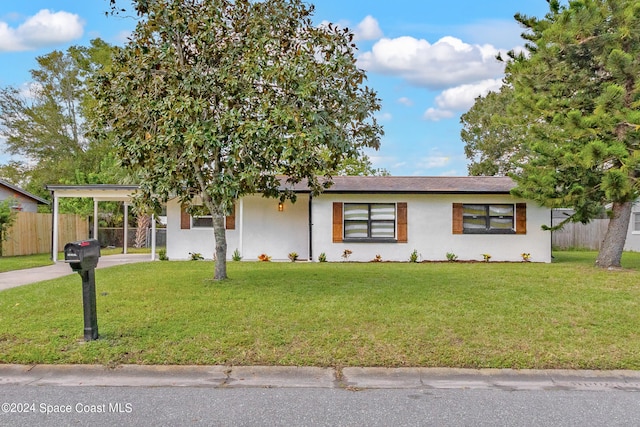 view of front of property with a carport and a front yard